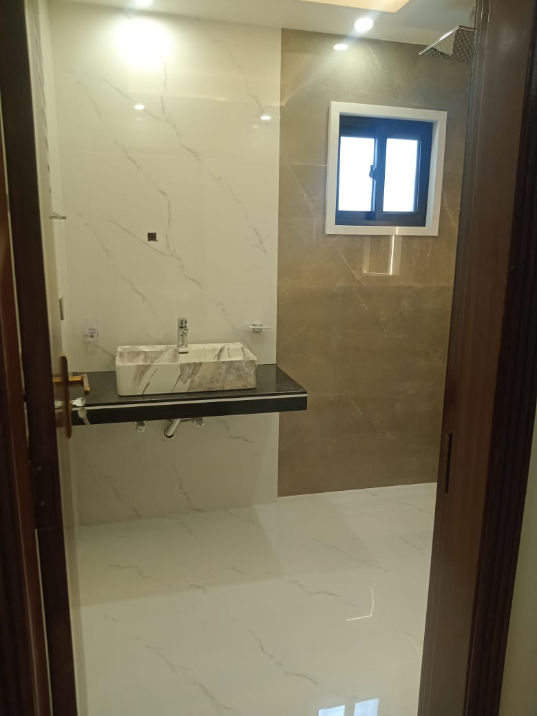 Modern bathroom renovation with marble tiles and contemporary fixtures